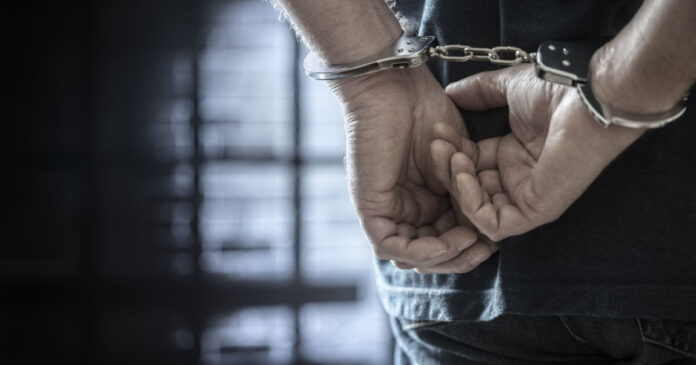 Criminal wearing handcuffs in prison